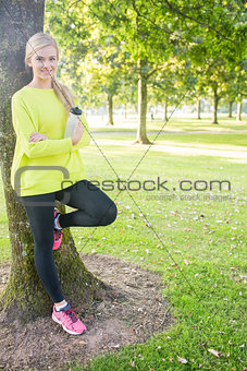 Fit cheerful blonde holding sports bottle