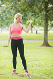Active focused blonde lifting dumbbells