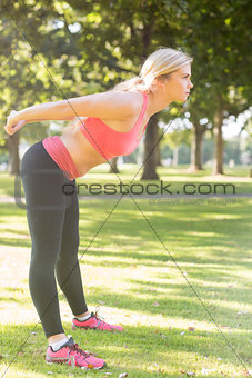 Active serious blonde stretching her body