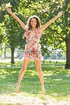 Stylish gorgeous brunette jumping in the air