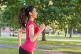 Pretty sporty woman jogging in a park