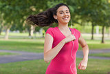 Motivated pretty woman jogging in a park
