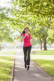 Gorgeous sporty woman jogging in a park