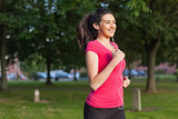 Motivated sporty woman running in a park
