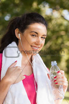 Cheerful young woman posing in a park
