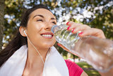 Gorgeous sporty woman drinking water out of a bottle