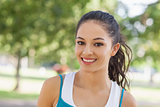 Portrait of cute sporty woman posing in a park