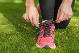 Close up of sporty woman tying her shoelaces