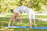 Fit young woman doing crab yoga pose