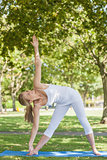 Young fit woman stretching her body with yoga pose