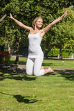 Cheerful young woman jumping in a park