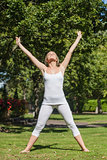 Blonde woman doing yoga in a park