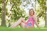 Gorgeous young woman posing on a lawn