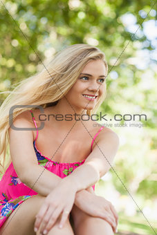 Lovely content woman relaxing on a lawn
