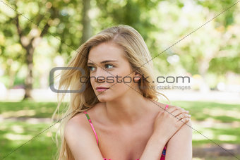 Serious young woman relaxing on a lawn