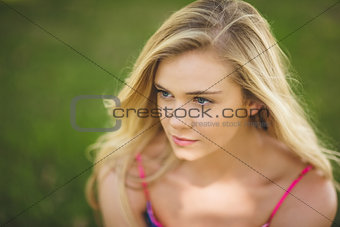 Thoughtful young woman relaxing on a lawn