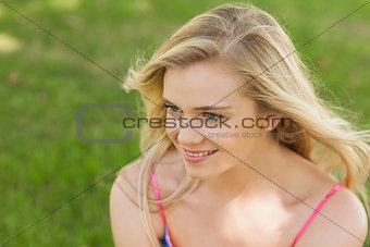 Attractive young woman sitting on a lawn