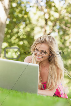 Smiling young woman using her notebook