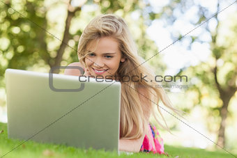 Happy blonde woman working with her notebook