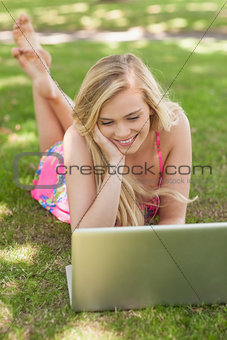 High angle view of content young woman using her notebook