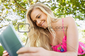 Peaceful amused woman using her tablet