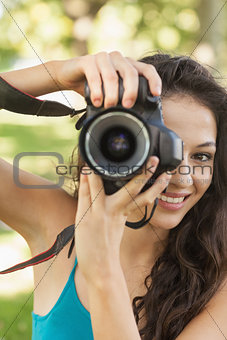 Lovely young woman taking a picture