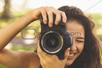 Beautiful brunette woman taking a picture