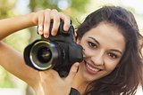 Gorgeous brunette woman holding her camera