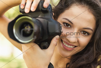 Gorgeous calm woman holding her camera