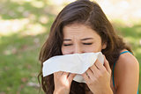 Sick young woman using a handkerchief