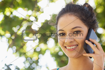 Portrait of pretty brunette woman being on the phone