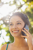 Cheerful young woman calling with her smartphone