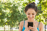 Joyful attractive woman dialling with her smartphone