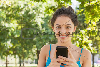 Portrait of young woman texting with her smartphone