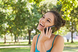 Happy young woman phoning with her smartphone