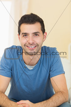 Casual smiling man relaxing on couch