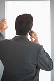 Rear view of businessman phoning