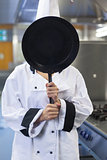 Chef covering face with pan