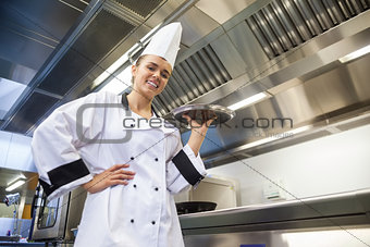Young smiling chef holding tray