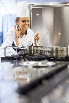 Young smiling chef showing ok sign