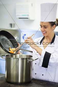 Young smiling chef preparing meal