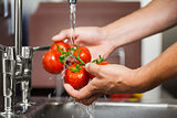 Kitchen porter washing tomatoes