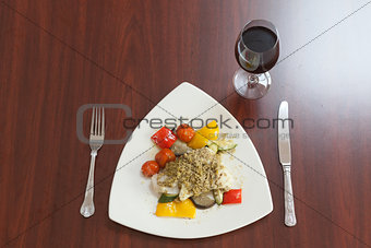 Overhead view of delicious fish dish with red wine