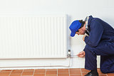 Handyman repairing a radiator