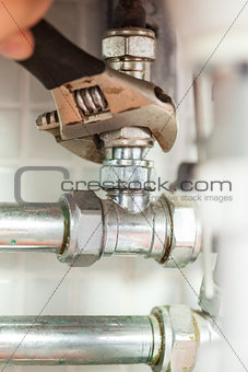 Close up of hand checking pipes