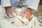 Close up of chef kneading dough