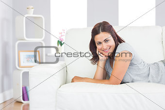 Cheerful young woman relaxing on a couch