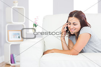 Beautiful casual woman using her smartphone for phoning