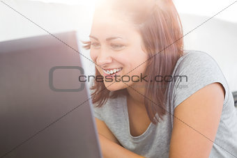 Joyful casual woman working with her notebook