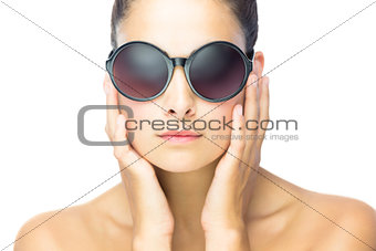 Front view of serious woman woman wearing round sunglasses